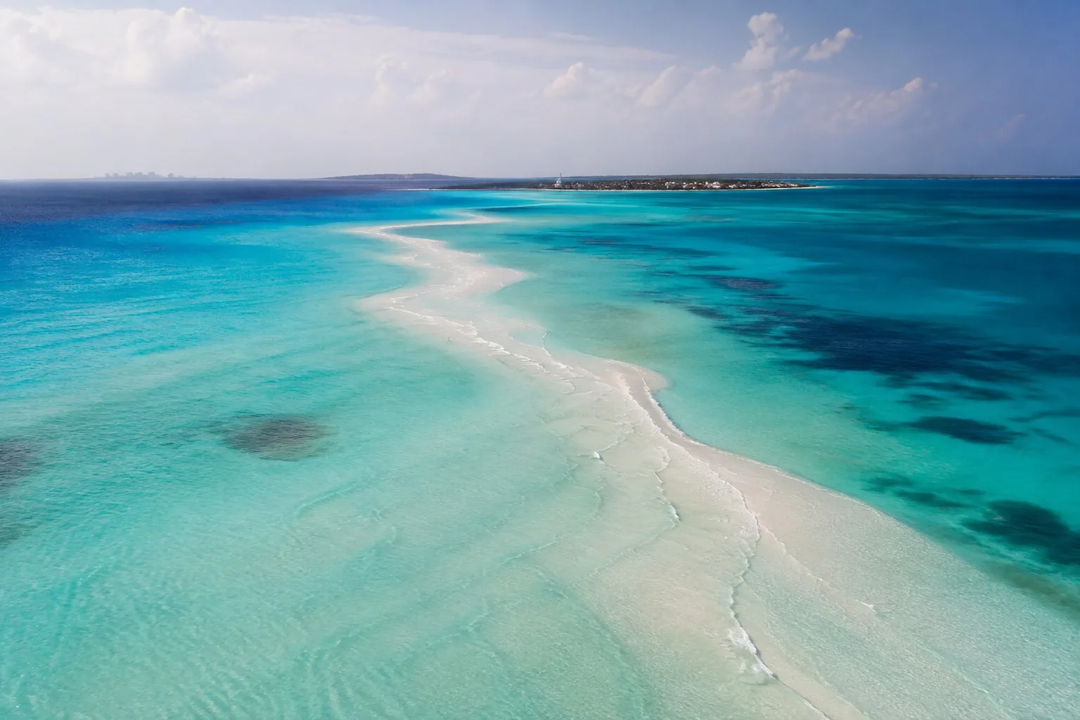 Aerial view of the sandbar and shallows off Isla Mujeres shading from turquoise to deep blue