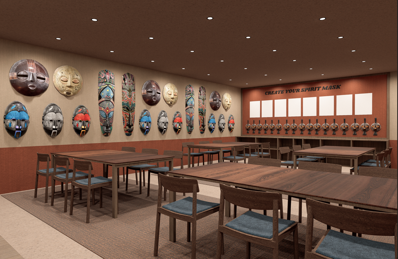 Room with wooden tables, chairs, and wall decorated with carved masks and a sign saying Create Your Spirit Mask.