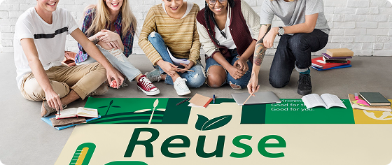 Group of five diverse young people sitting on floor around a large 'Reuse' sign with books.