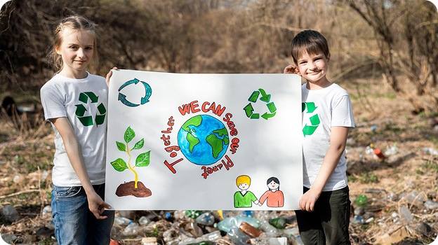 Two children in recycling shirts hold a sign saying ‘Together we can save our planet’ with earth and recycling symbols.