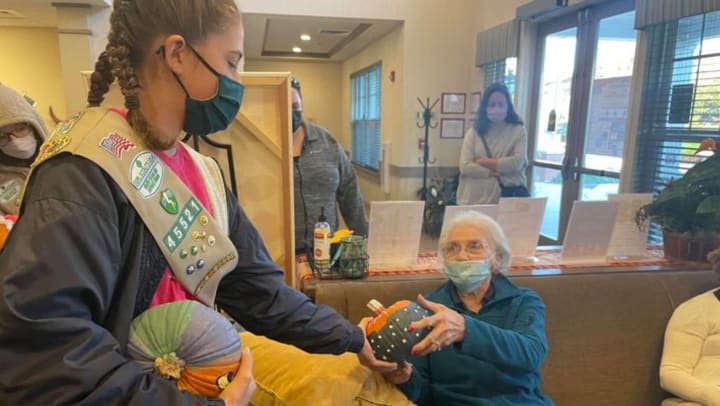 Girl Scouts Bring Pumpkins (and Joy) to Emerald Place Memory Care Residents