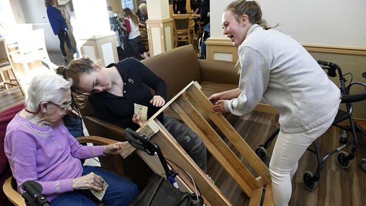 Chelsea Place Memory Care Residents and High Schoolers Build Dog Stick libraries for the Aurora Community