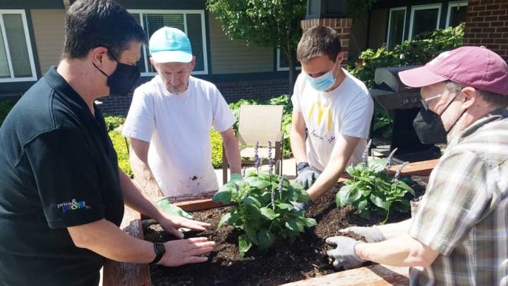 Volunteers Help Harvester Place Residents Plant Flower Gardens