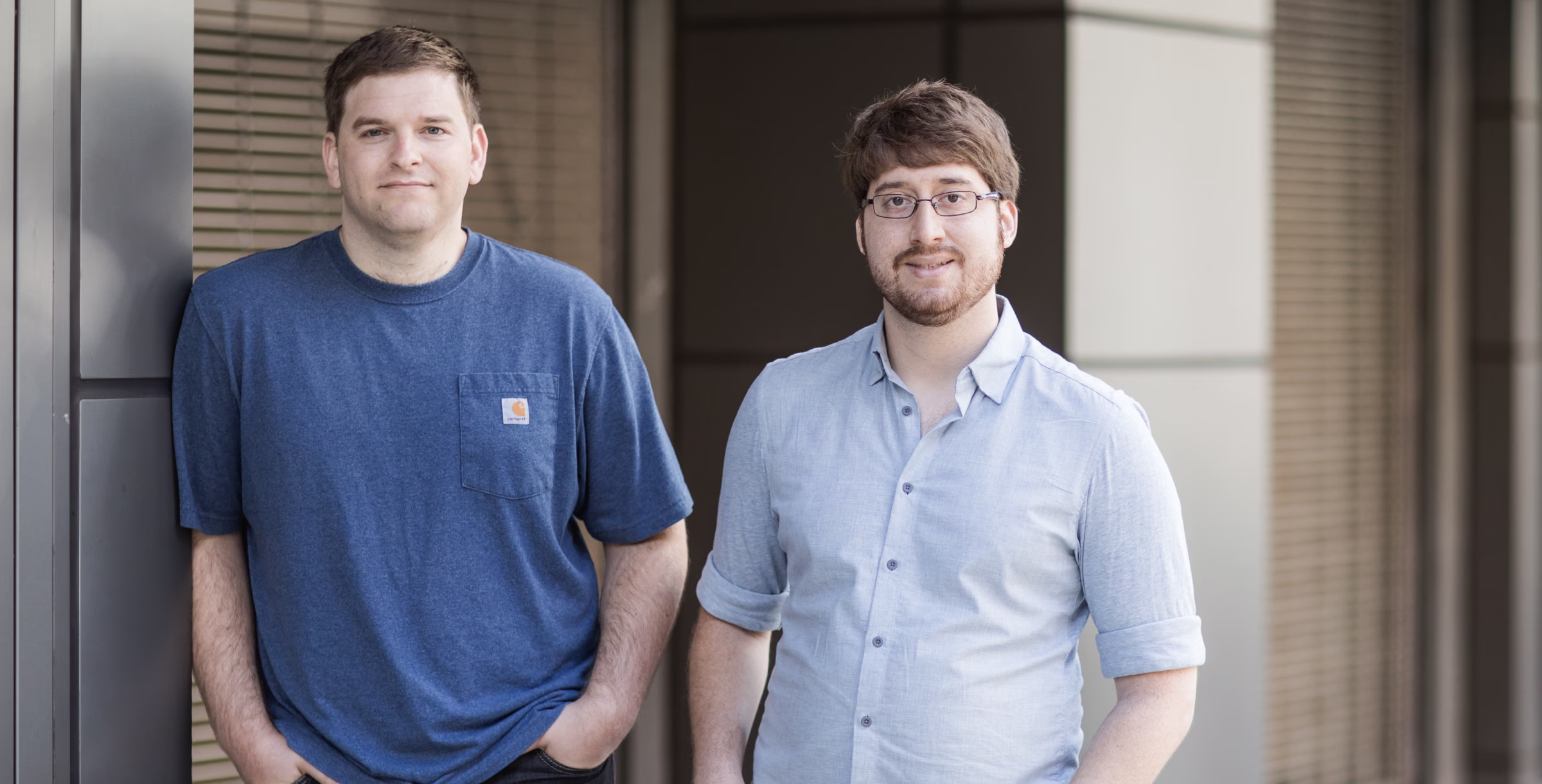 Two 0x Labs team members standing outside their office