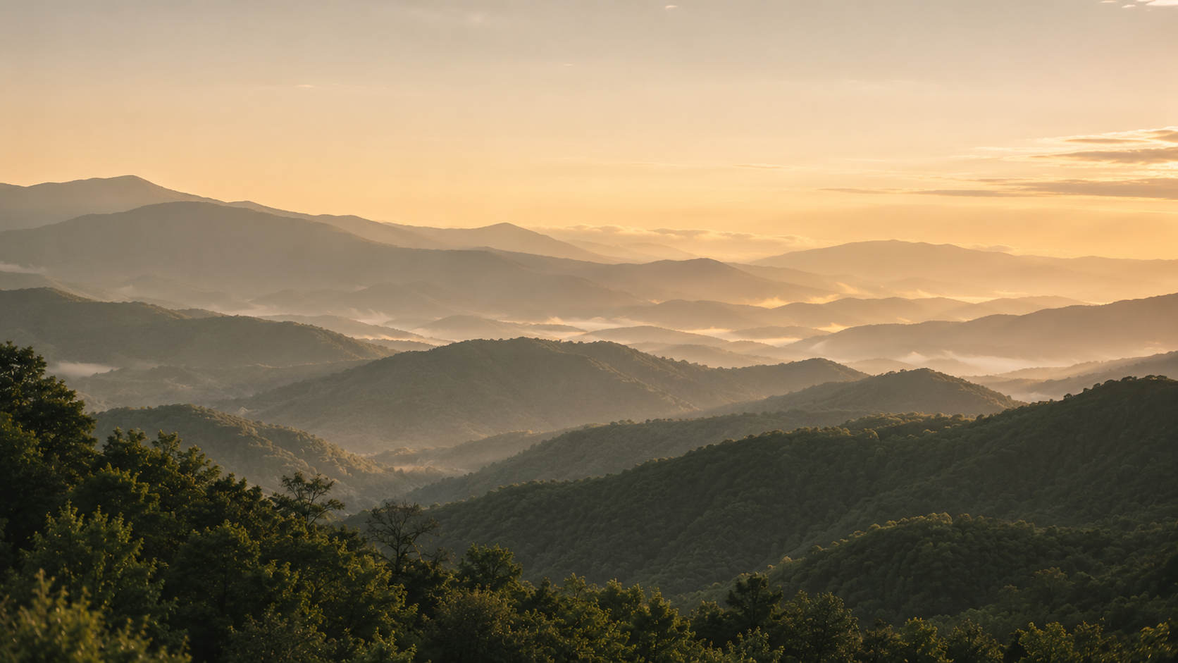 Layered Blue Ridge mountain ridgelines fading into golden morning mist near Sapphire, NC