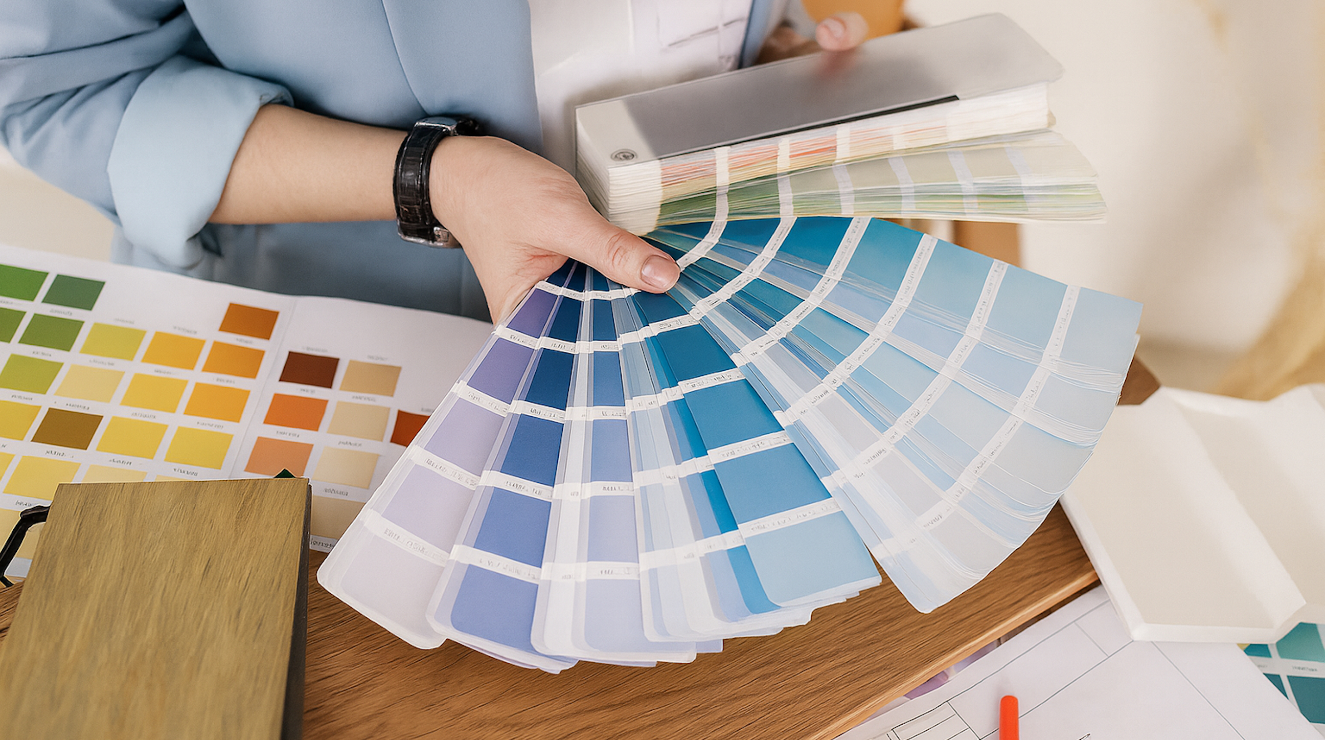 1st Design Studio designer fanning out paint swatches for paint color selection