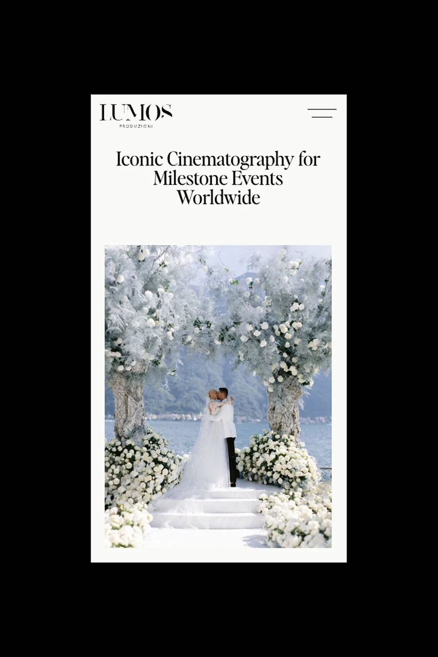 Lumos Produzioni mobile homepage with "Iconic Cinematography for Milestone Events Worldwide" headline and lakeside wedding ceremony framed by white floral arches