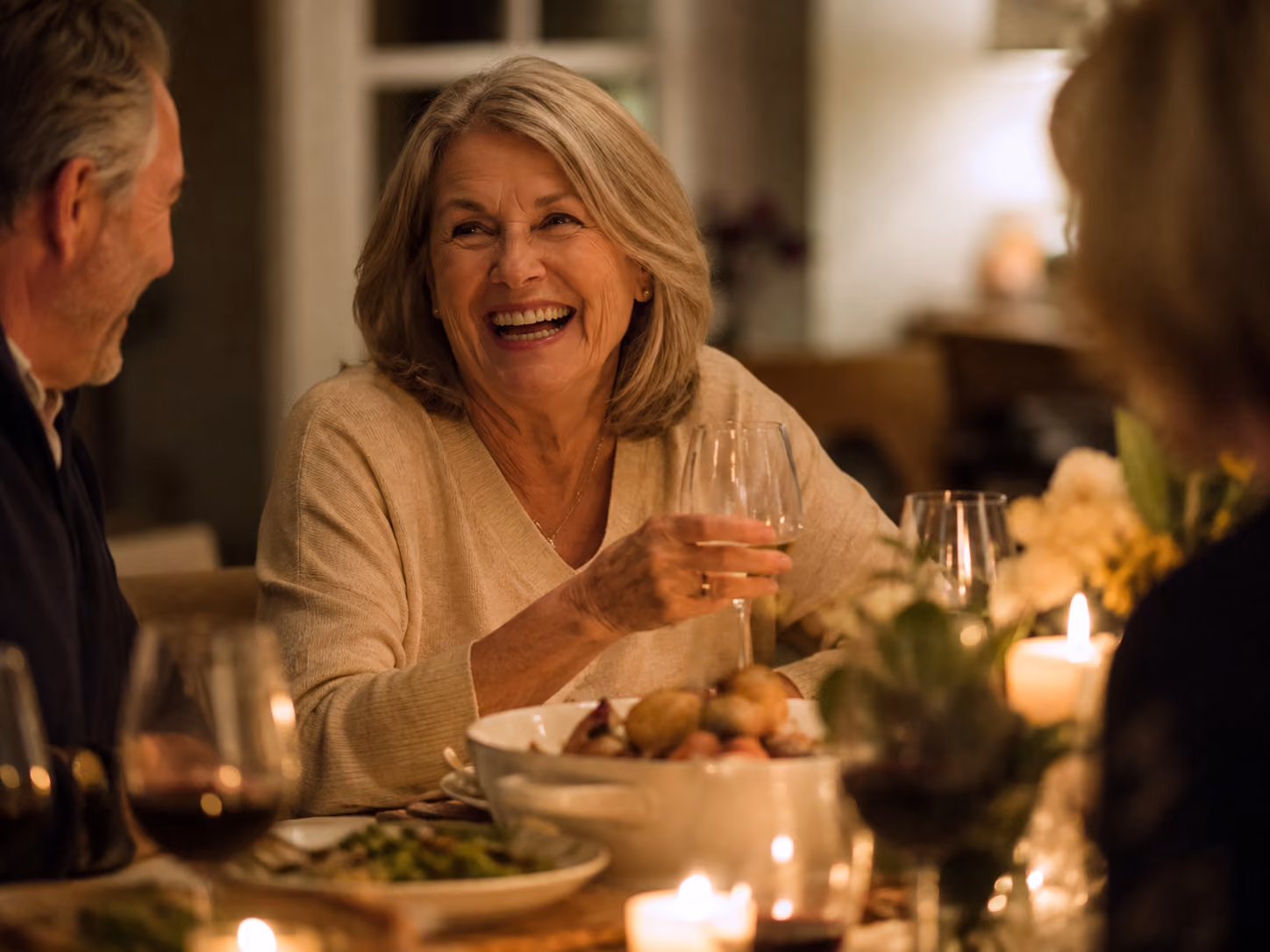 Couple sharing a meal at a dinner table, eating comfortably after full mouth dental implant treatment
