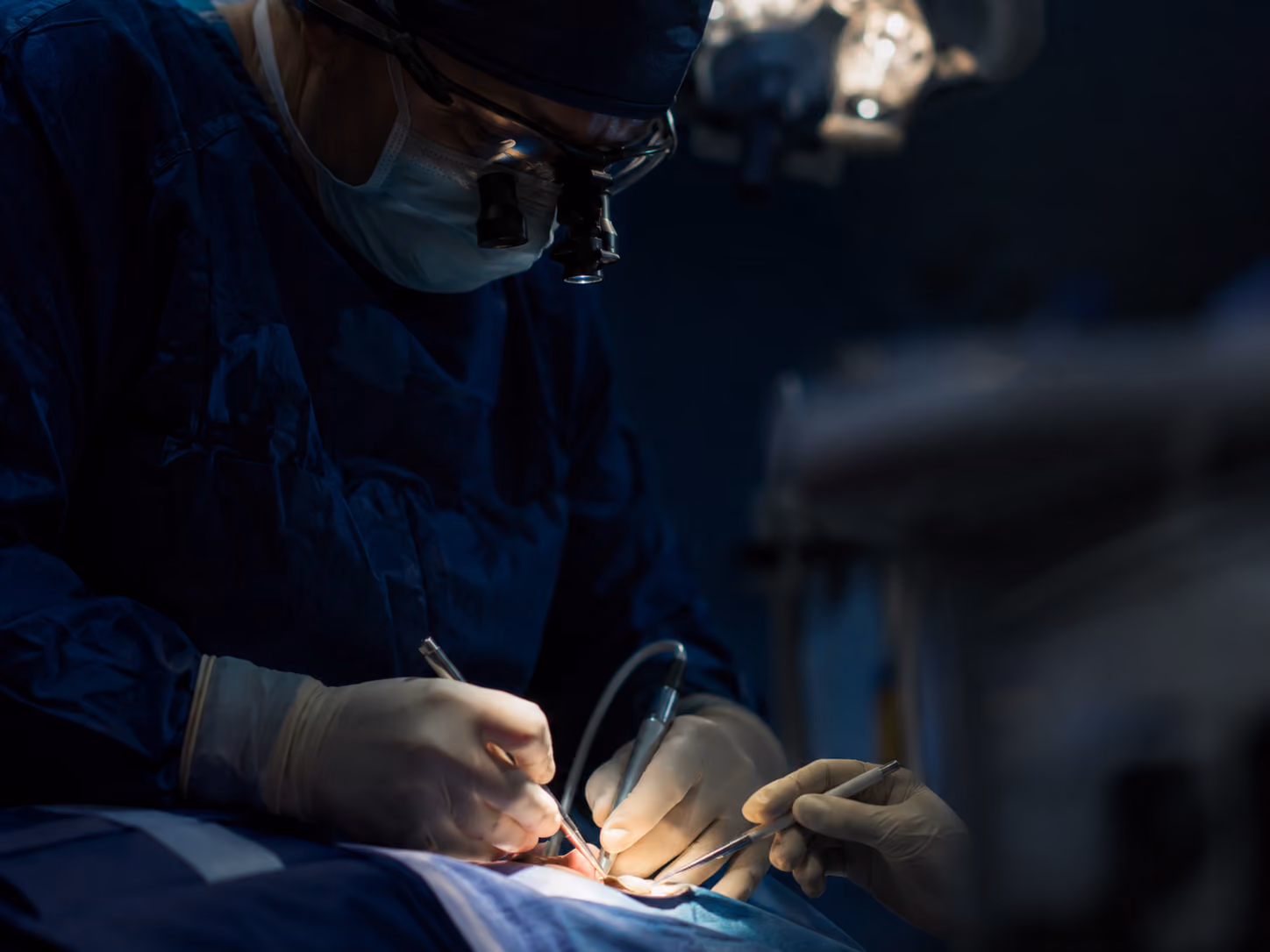 Board-certified oral surgeon placing dental implants under in-house IV sedation