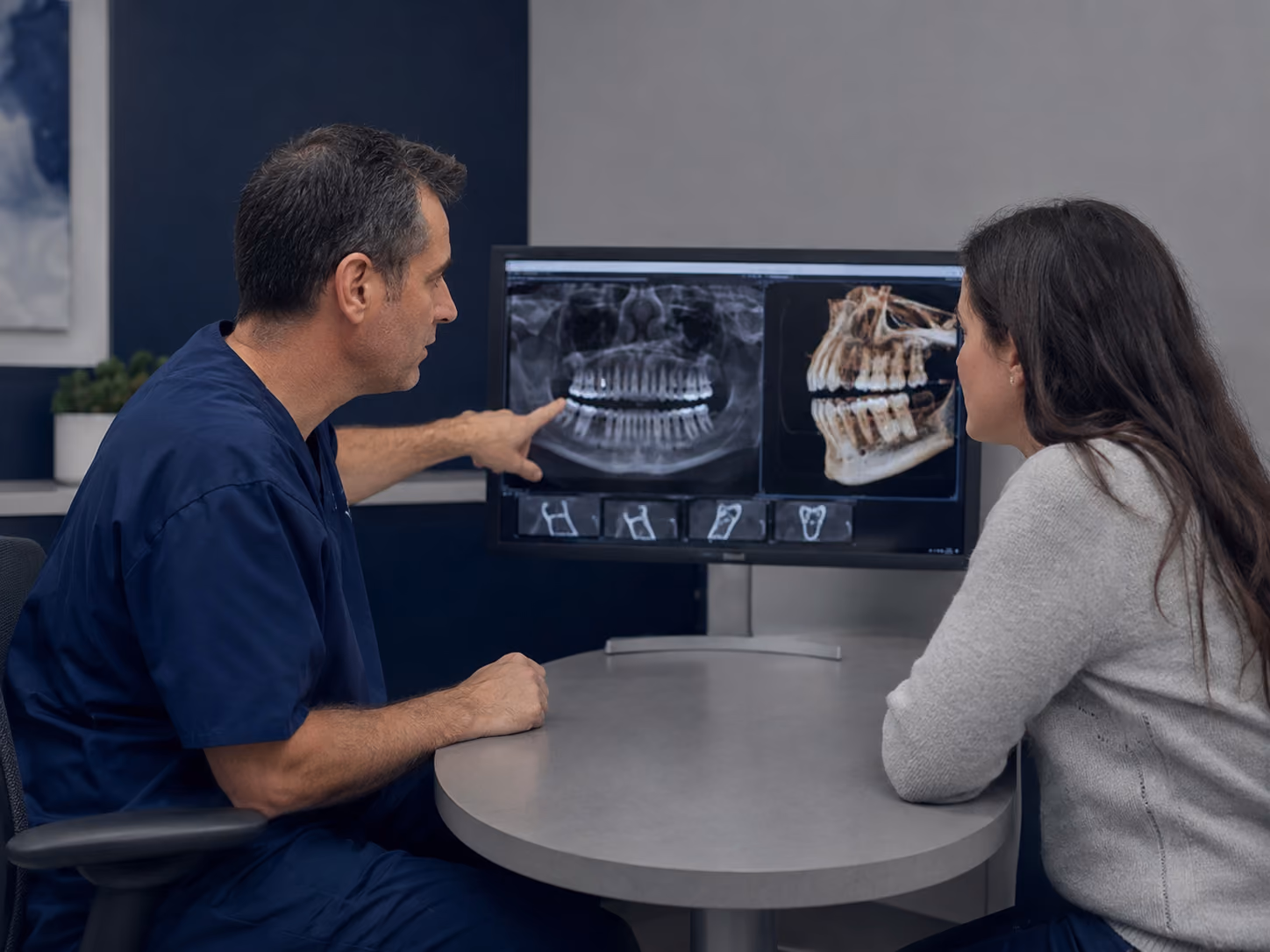 Doctor reviewing CBCT imaging with a patient at a full-arch implant consultation in Bonney Lake, WA
