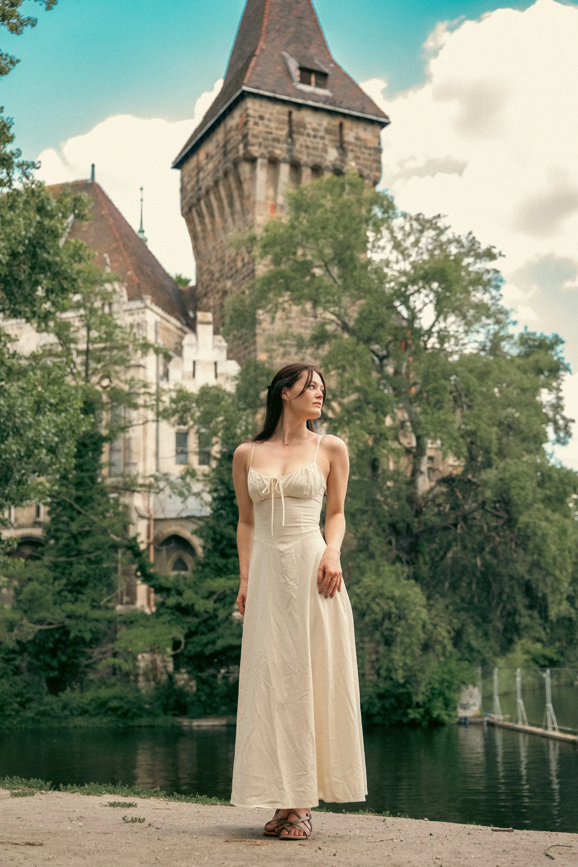 Model Julia by the water in front of a castle, In White editorial by GROOVE Media