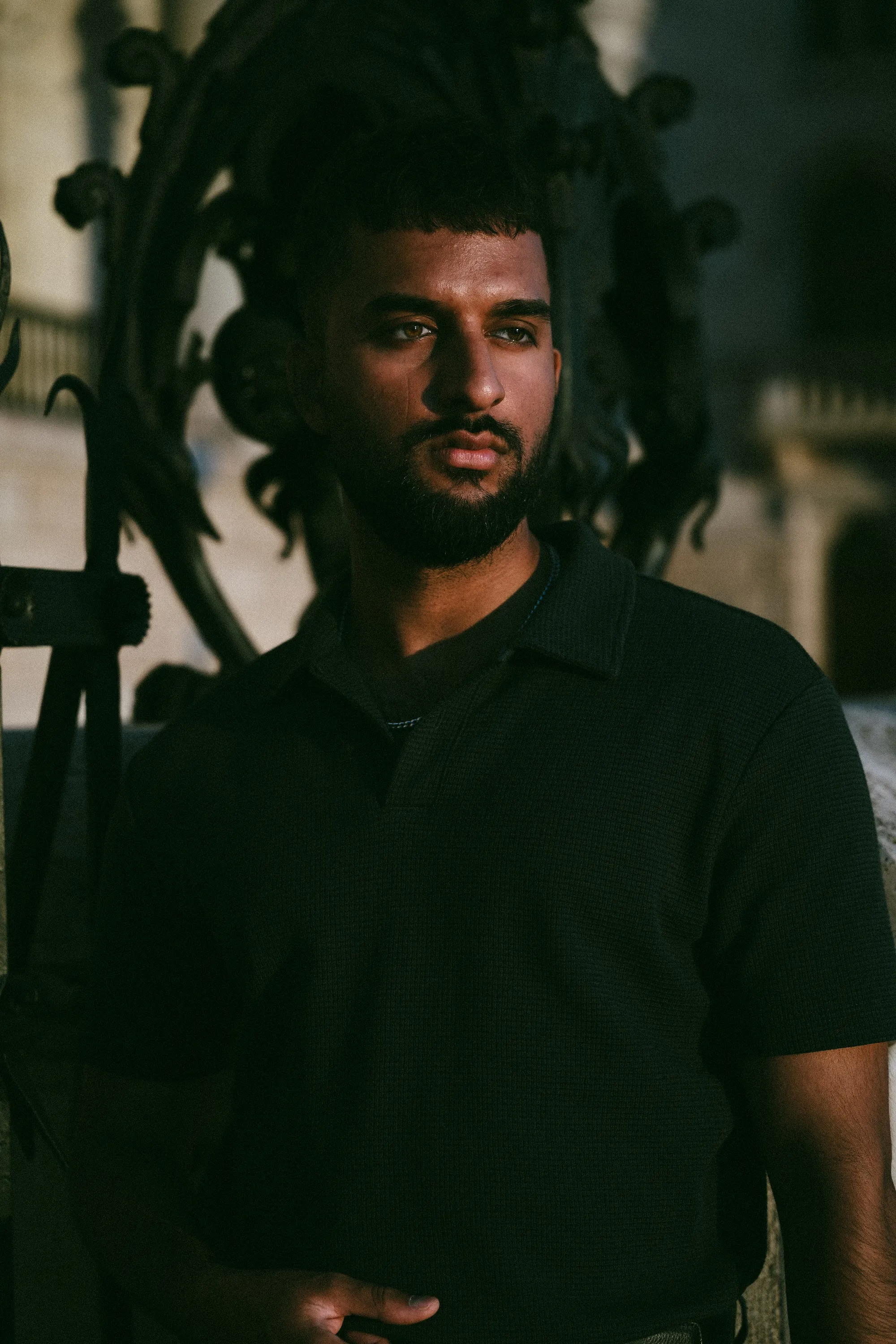 Low-key portrait of model Zoubi in deep shadow, Parliament Gold editorial by GROOVE Media