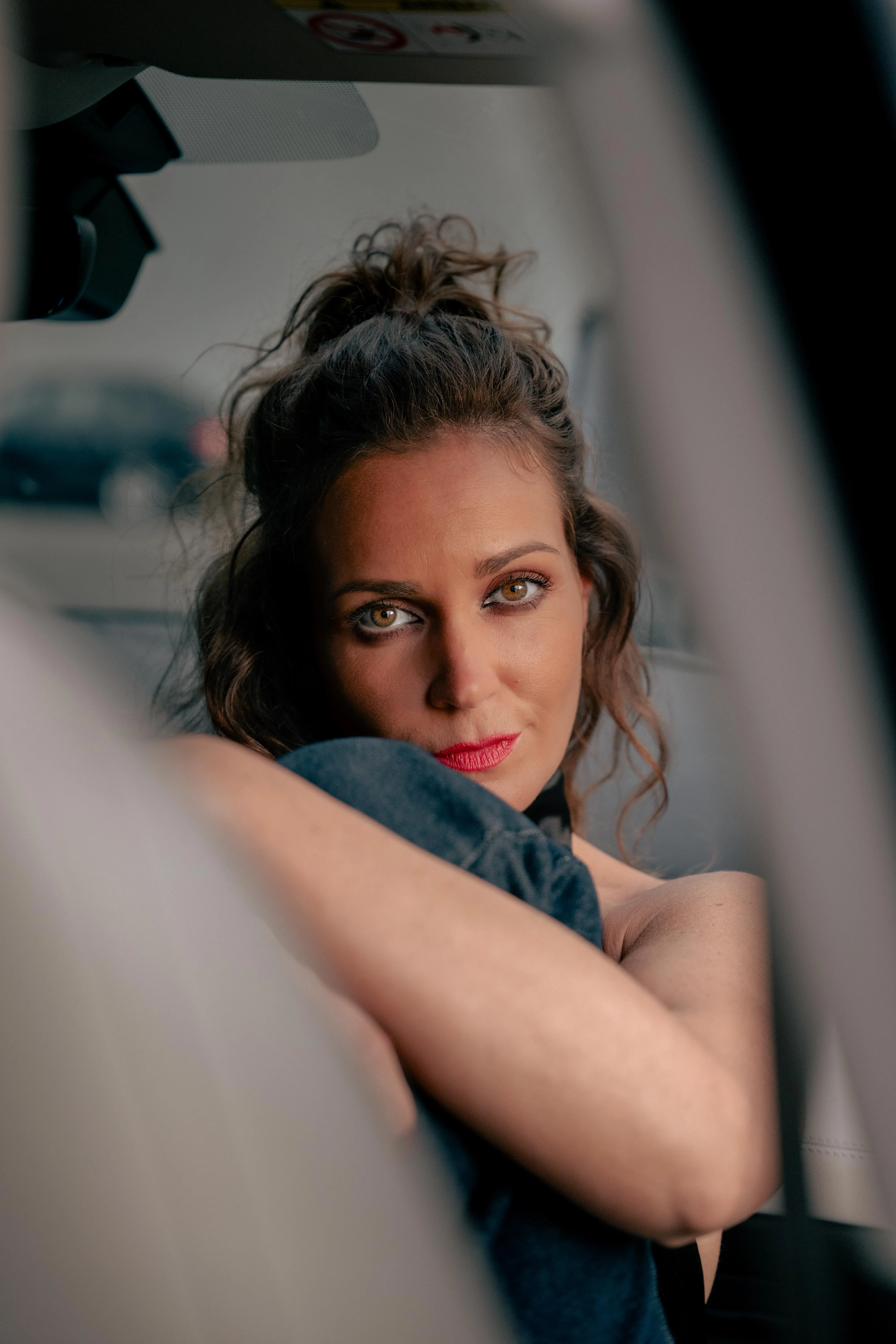 Kinga looking back between the front seats of a car, portrait by GROOVE Media