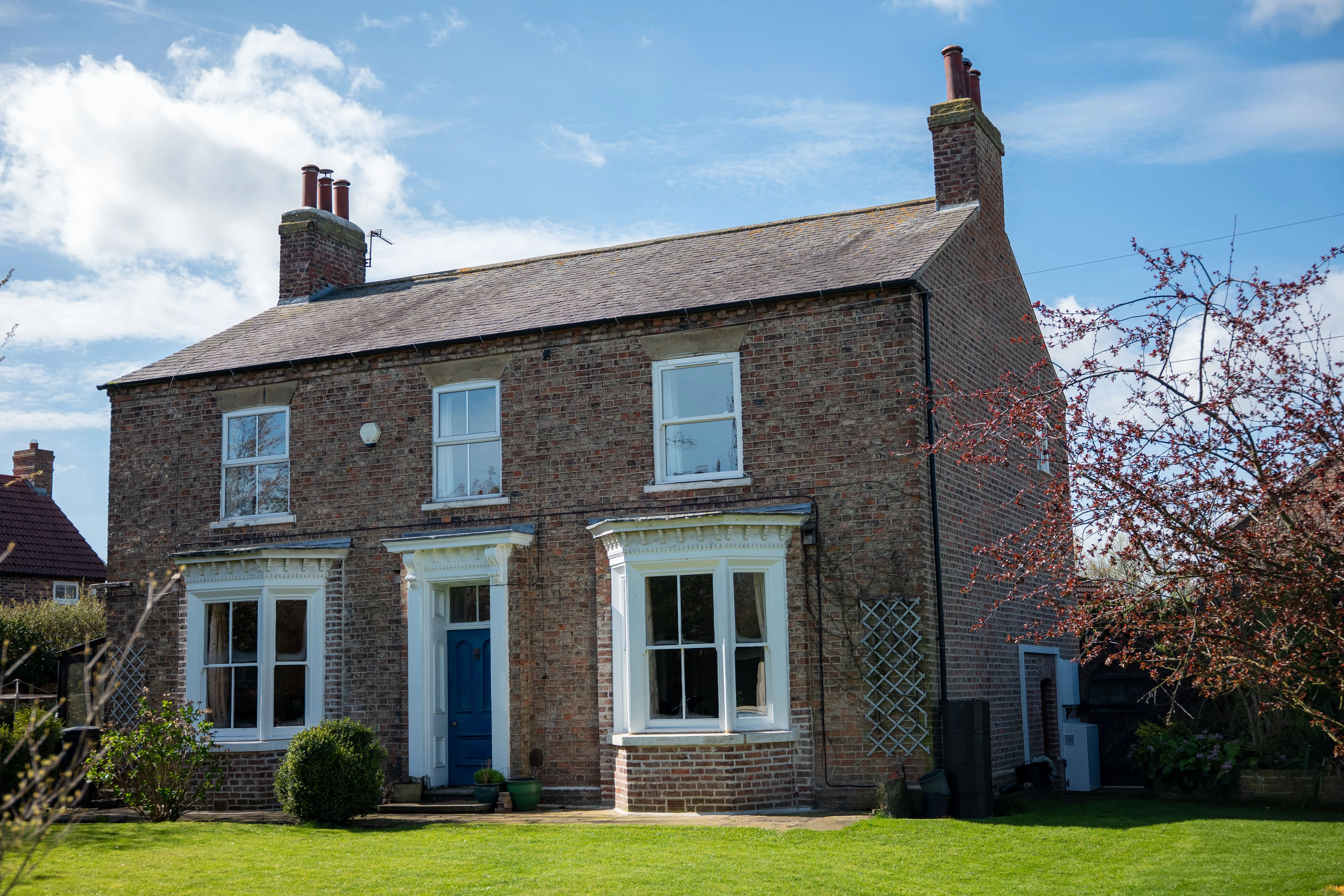 Red-brick Georgian farmhouse and lawn in Yorkshire, real estate photography by GROOVE Media