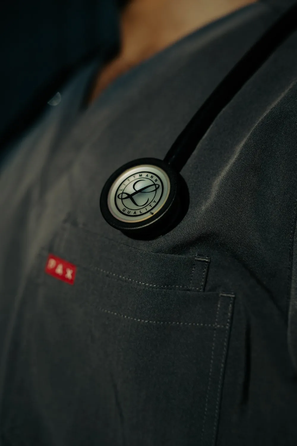 Close-up of a PAX Scrubs top with a stethoscope, PAX Scrubs campaign detail