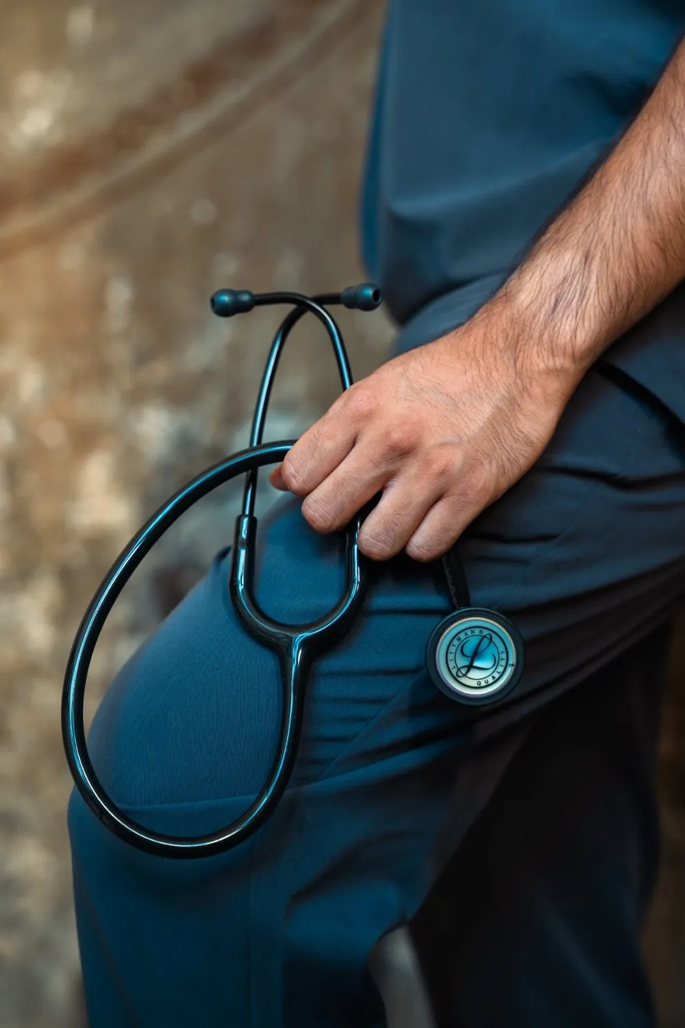 Detail of a stethoscope held at the hip in PAX Scrubs, PAX Scrubs campaign