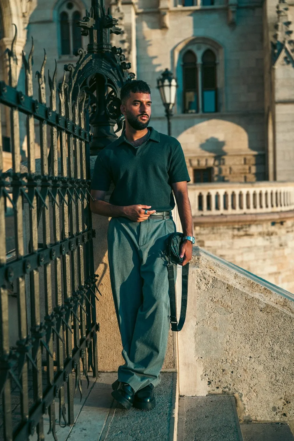 Model Zoubi leaning on a wrought-iron gate at the Hungarian Parliament, Parliament Gold editorial