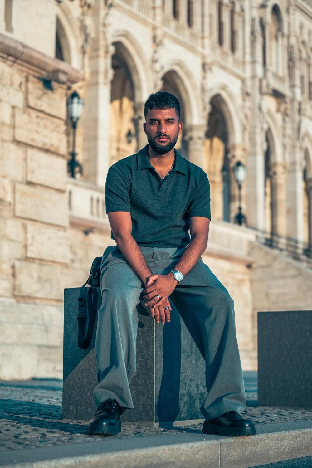 Model Zoubi seated on a stone ledge at the Hungarian Parliament, Parliament Gold editorial