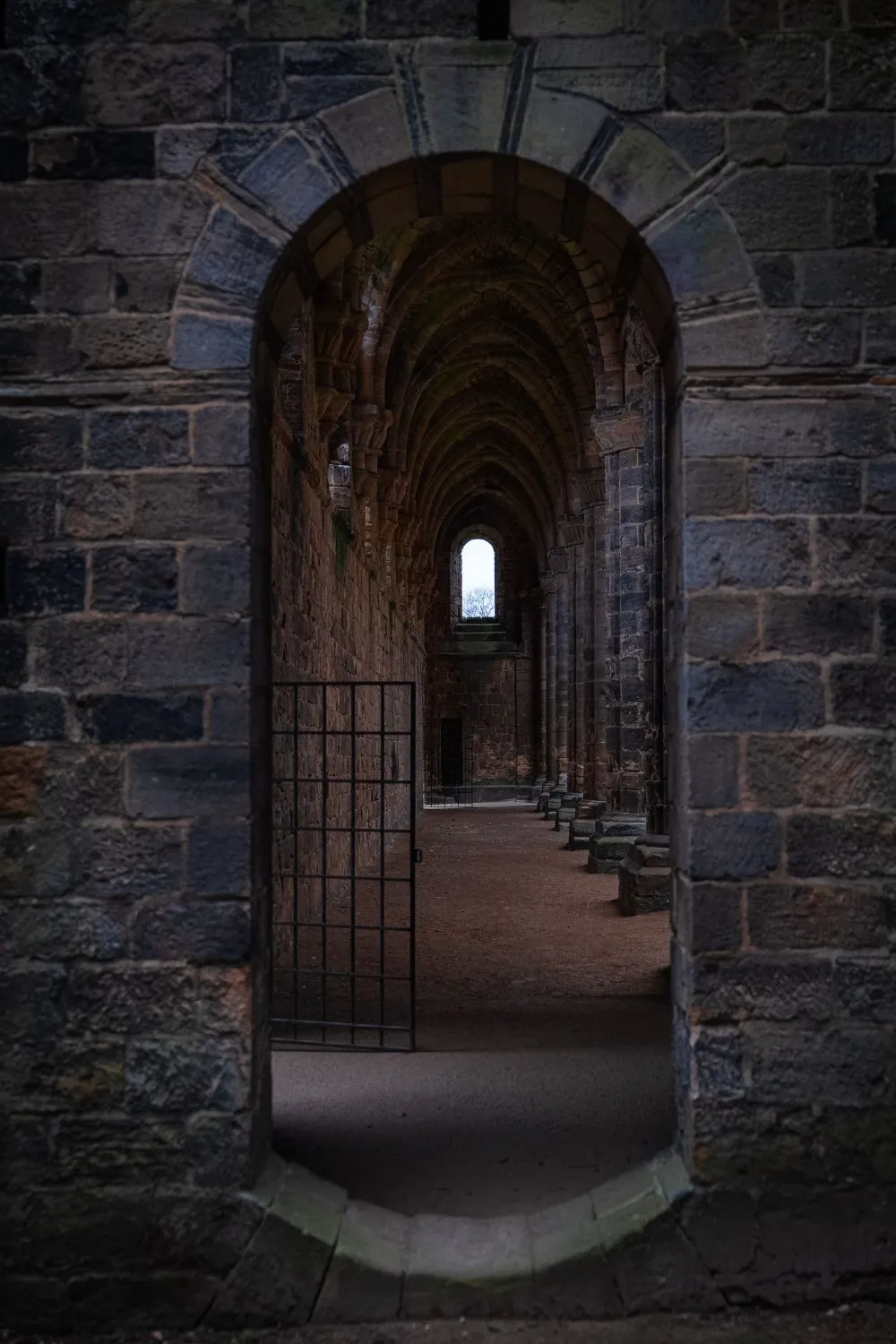 Stone archway and vaulted passage inside a medieval abbey ruin, UK, photographed by GROOVE Media