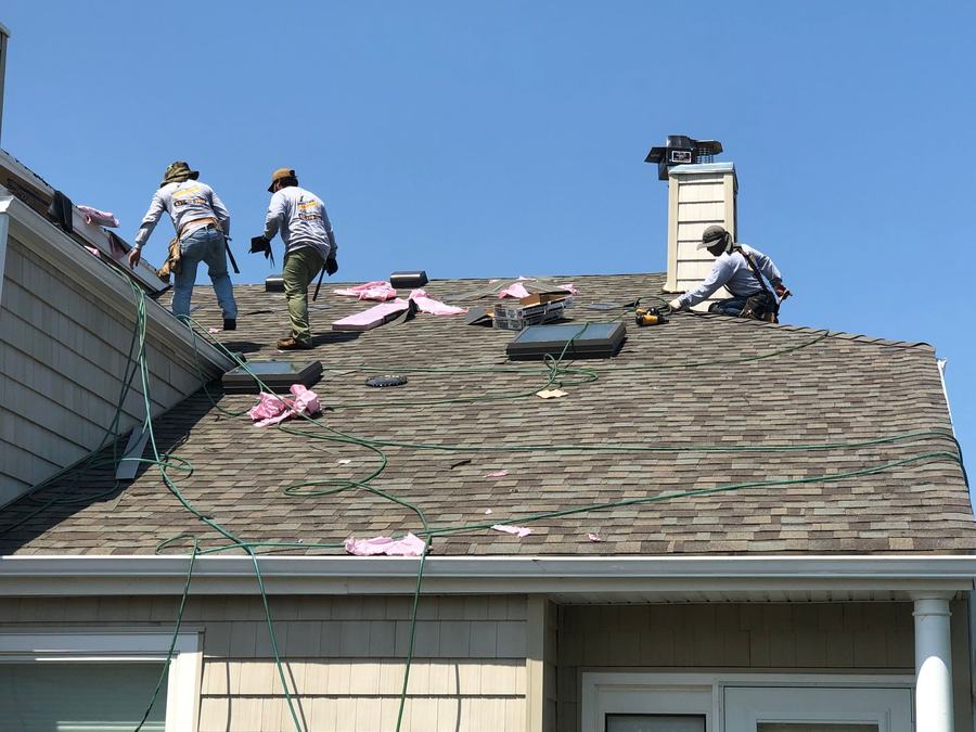 Smart Choice Contracting crew tearing off an old asphalt roof 