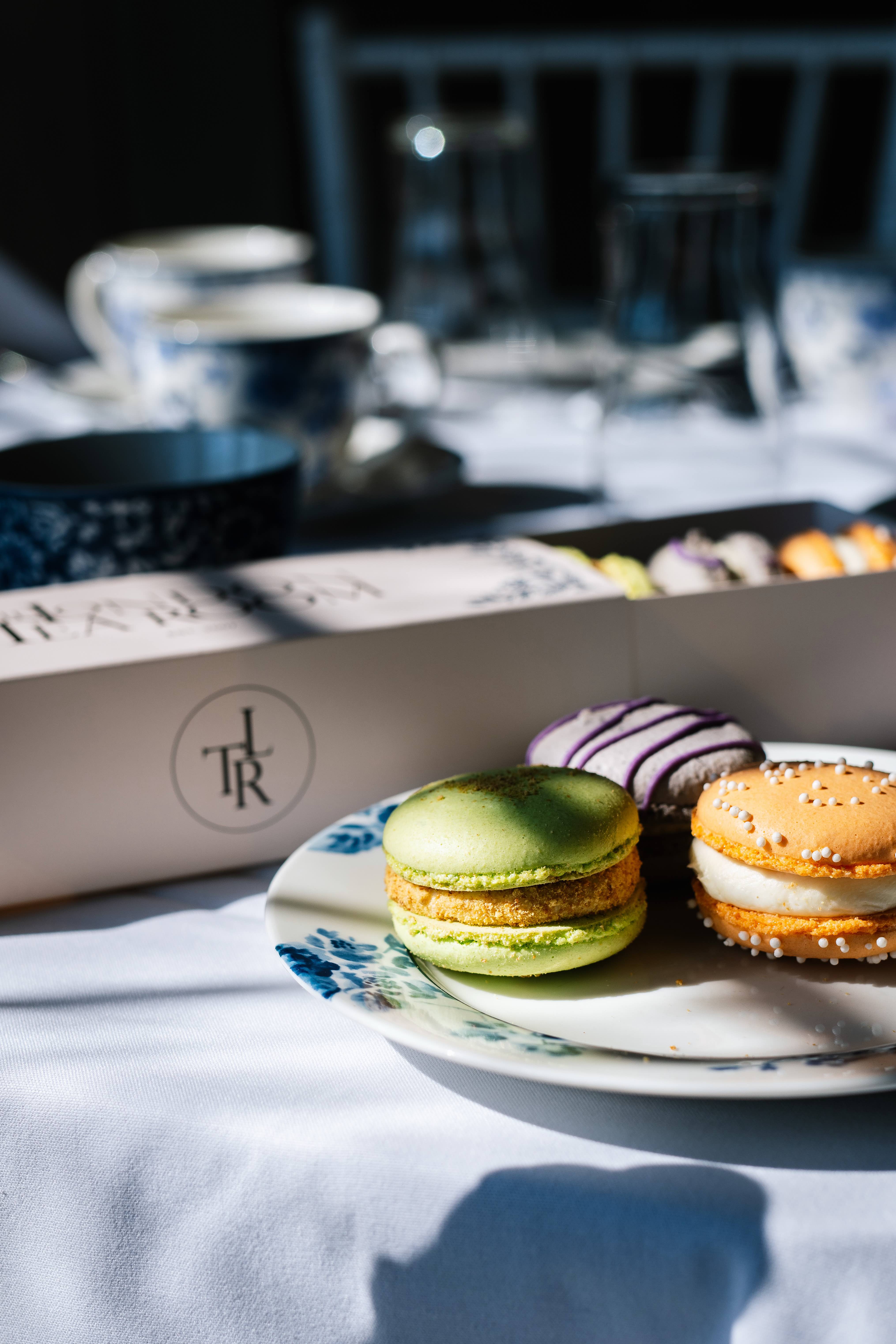 London Tea Room boxes with French macarons on blue-and-white china