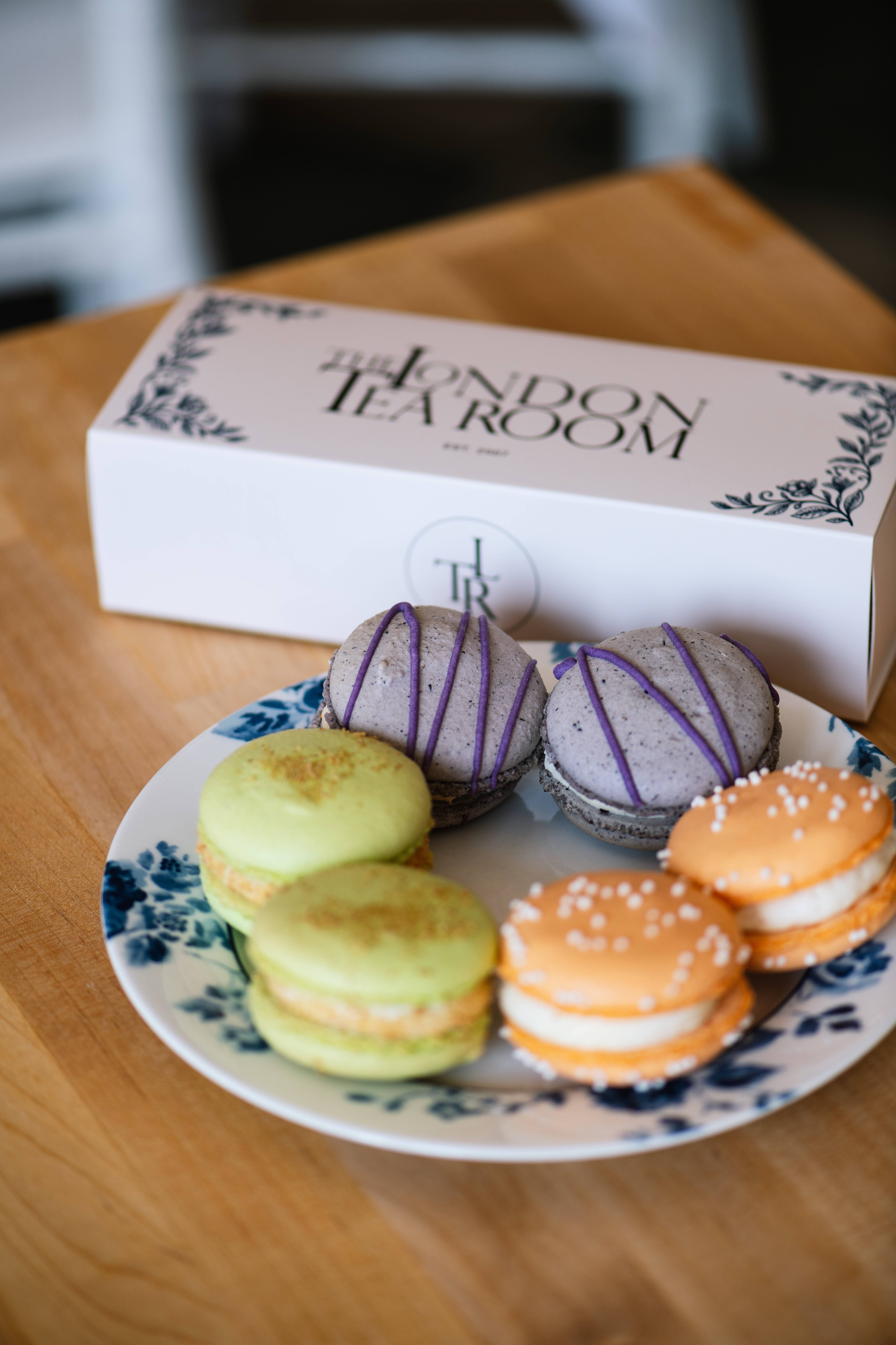A plate of pistachio, lavender, and salted caramel macarons