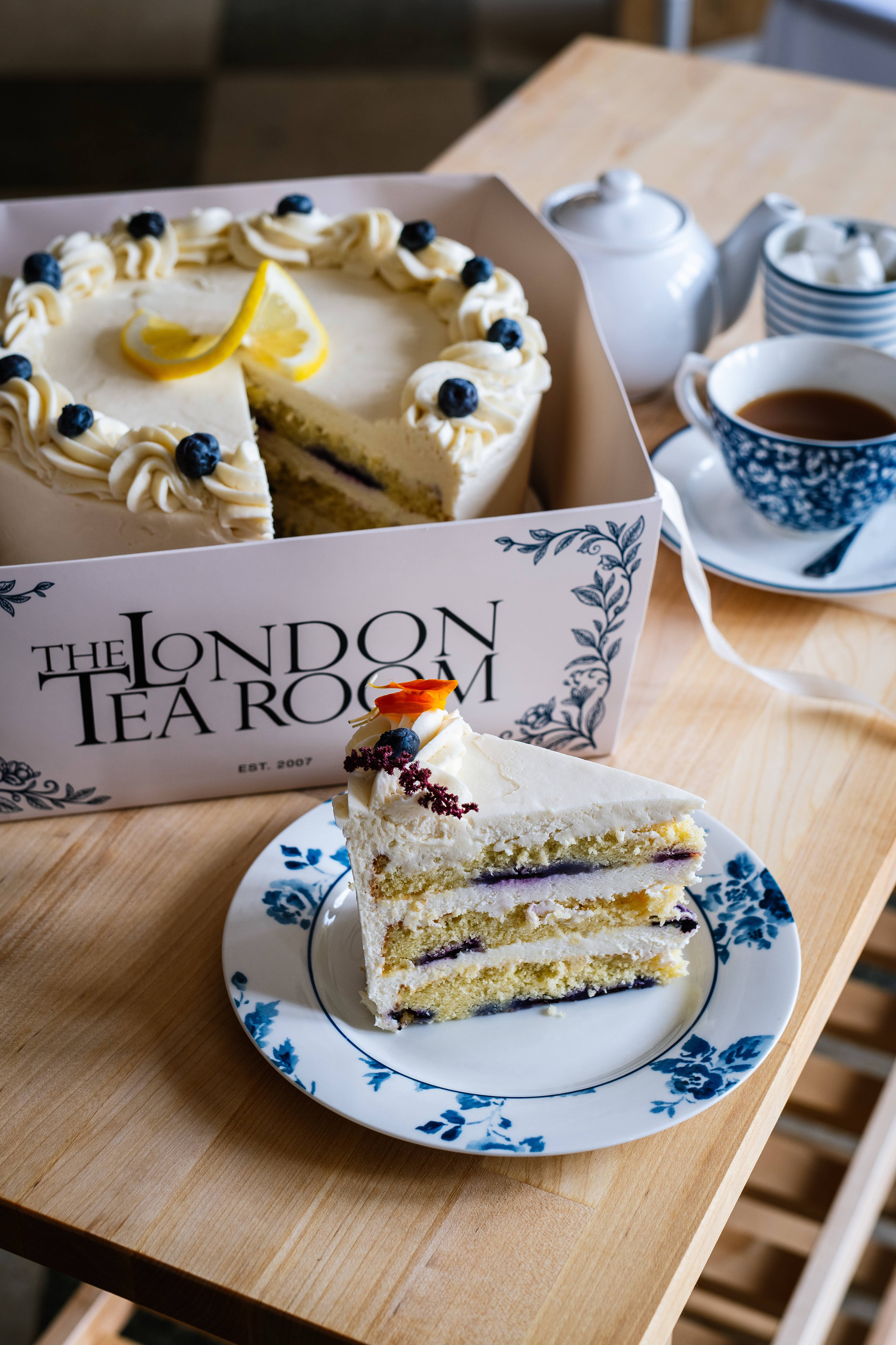 A slice of layered sponge cake with tea at The London Tea Room