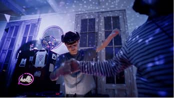 Two people dancing in a room with a disco ball casting light patterns on walls and ceiling.