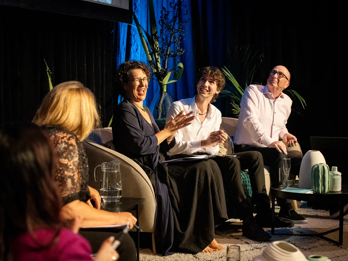 A panel discussion in front of an audience