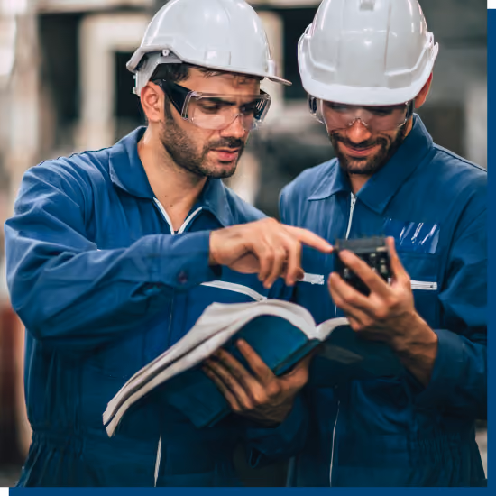 Oil and gas field service technicians reviewing equipment documentation