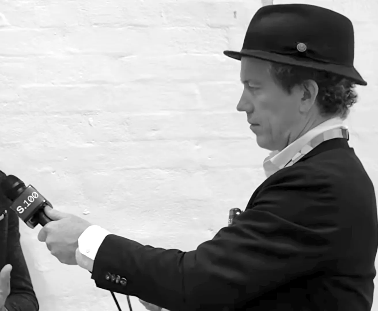 Sholto Macpherson conducting an interview at a conference in 2026