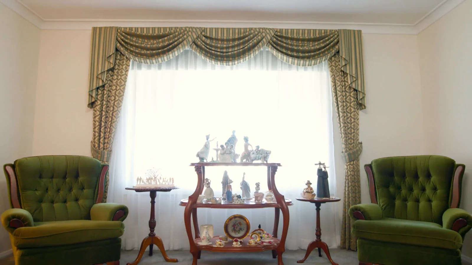 Swagged and tailed curtains over sheers in a formal sitting room, by Quicksew