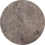 Close-up of a textured gray and brown stone surface in a circular frame.
