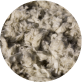 Close-up of matted, dirty carpet fibers with various debris tangled within.