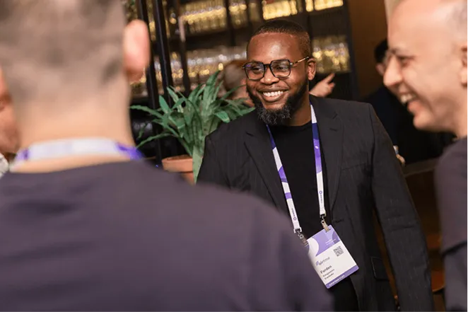 Delegates networking and laughing at a conference