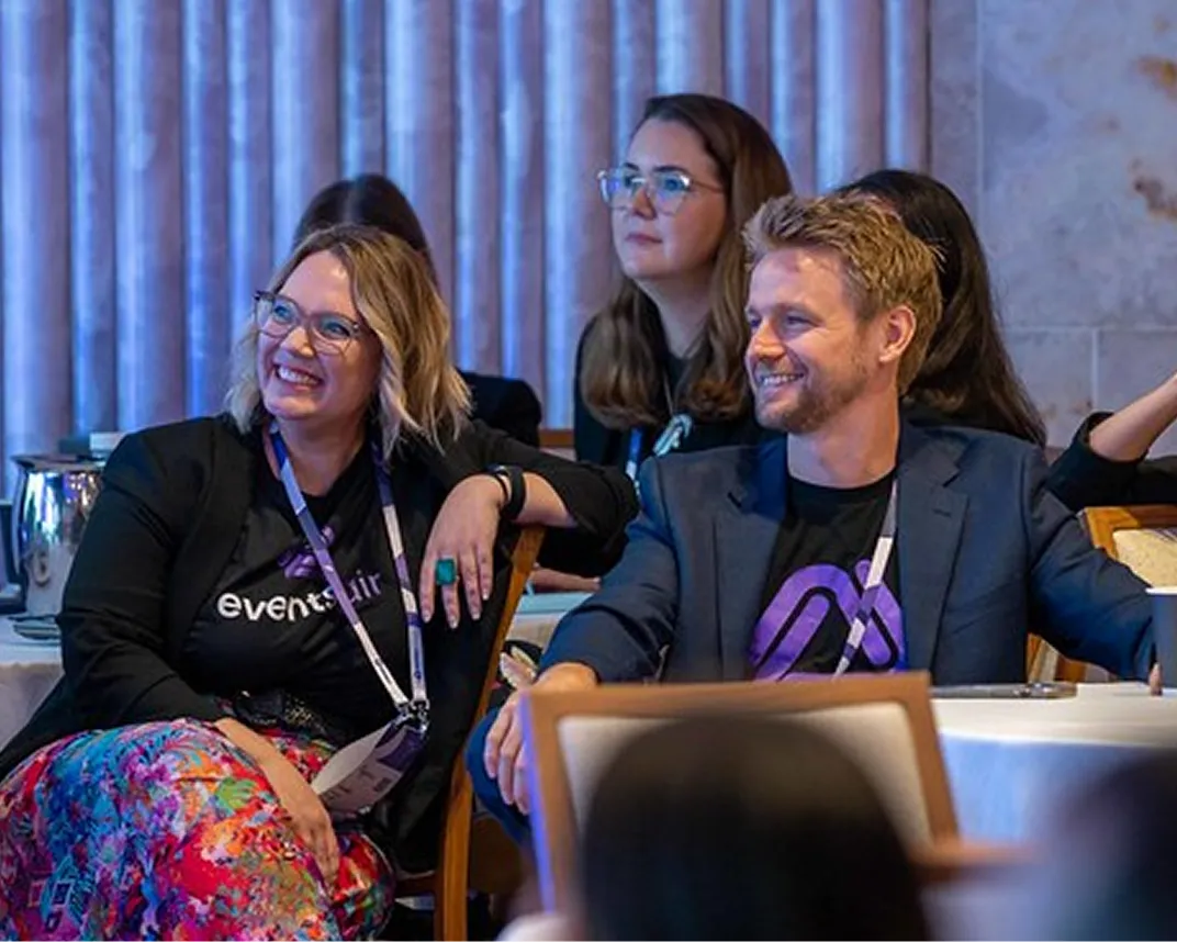 EventsAir team members in branded shirts seated in a conference audience