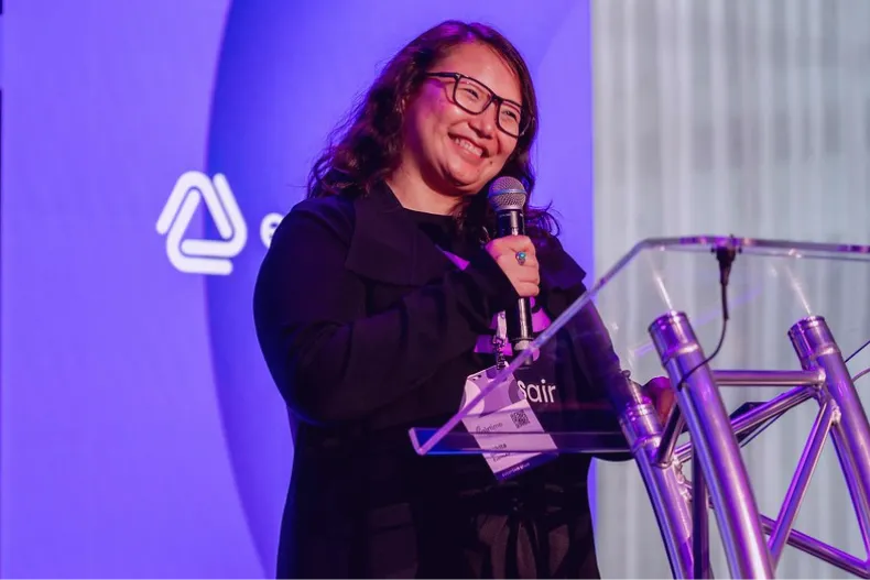 EventsAir team member speaking at a lectern on stage