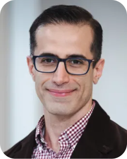 Portrait of Mehdi Khalili wearing glasses and a checked shirt