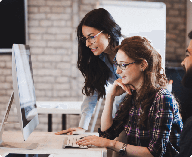 Two colleagues reviewing event data together on a desktop computer