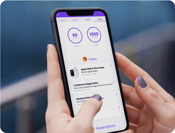 Hands holding a phone showing an event app prize and gamification points screen
