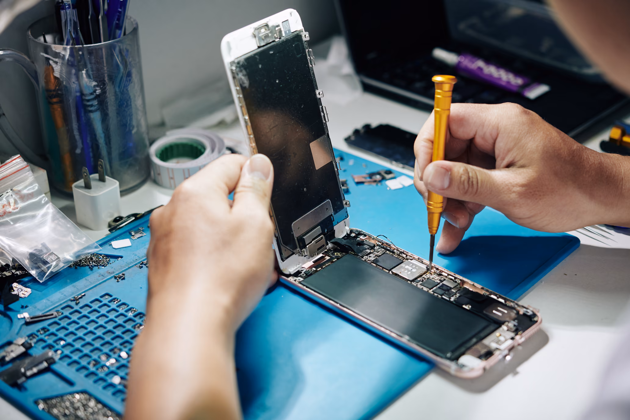 Technician replacing a phone battery