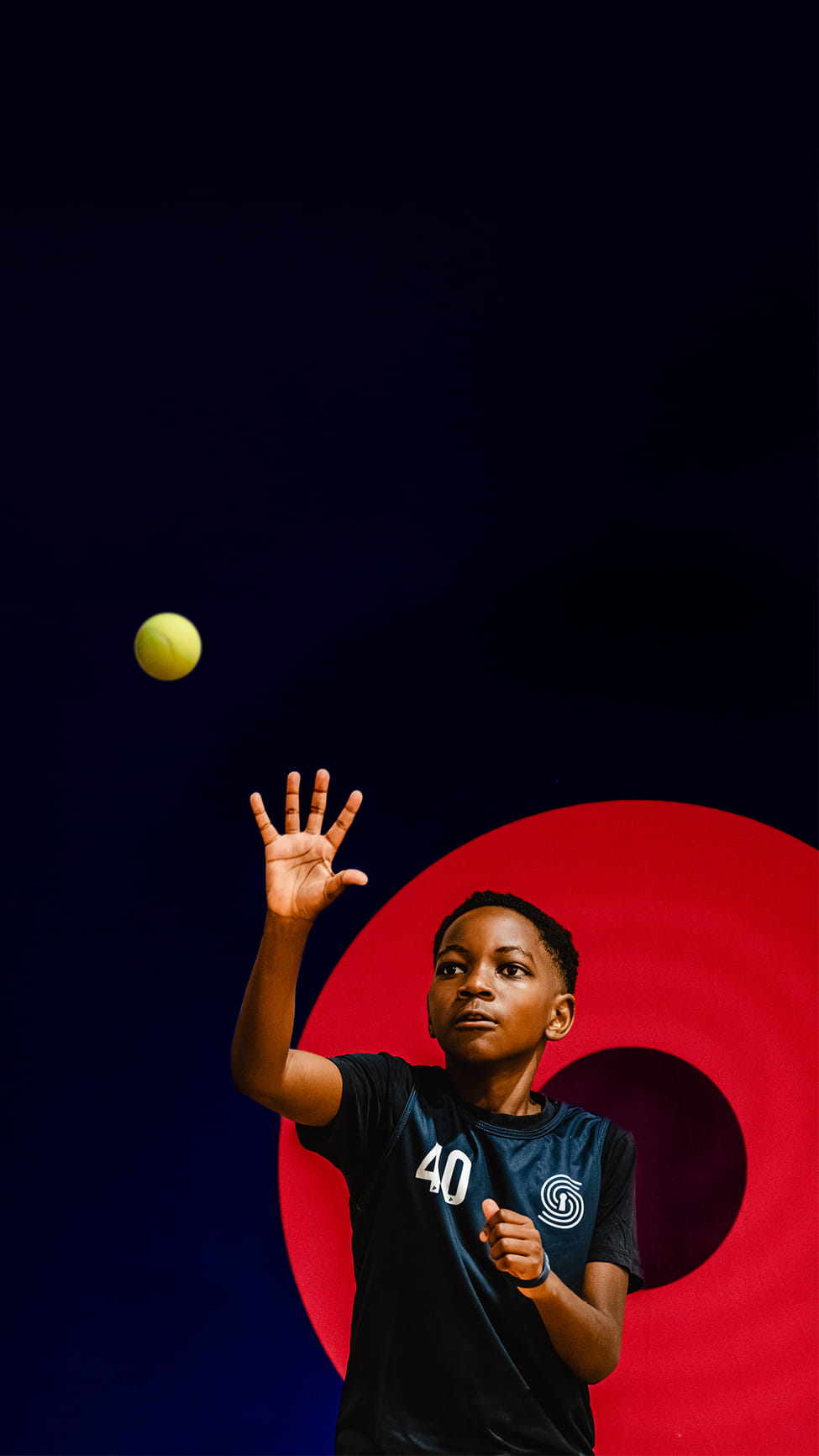 Young athlete in a numbered jersey reaching to catch a ball during a SportsKey assessment