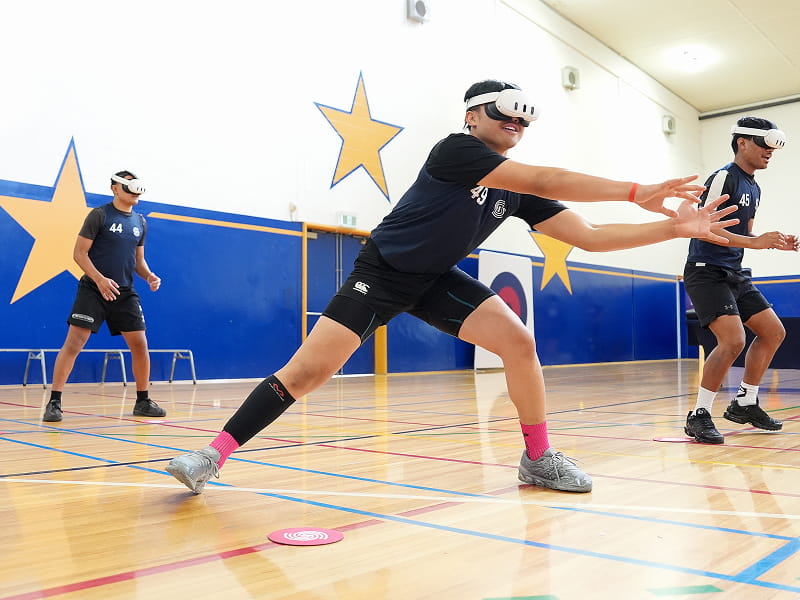 Young athletes wearing VR headsets performing a visual awareness and reaction test