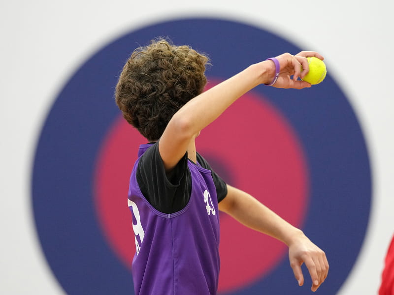 Athlete throwing a ball towards a target board during a SportsKey throwing accuracy assessment