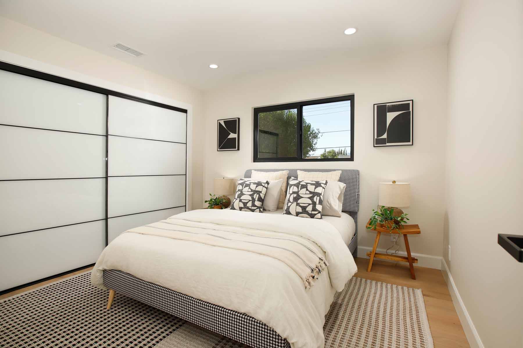 Renovated bedroom with sliding closet doors and white oak floors at 19939 Hemmingway Street, Winnetka