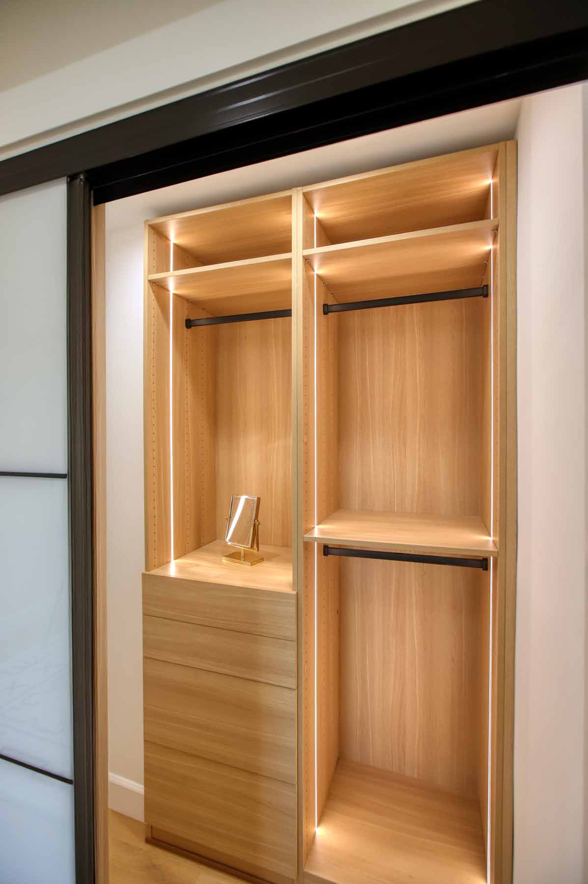 Custom lit white oak closet organizer with built-in drawers at 19939 Hemmingway Street, Winnetka