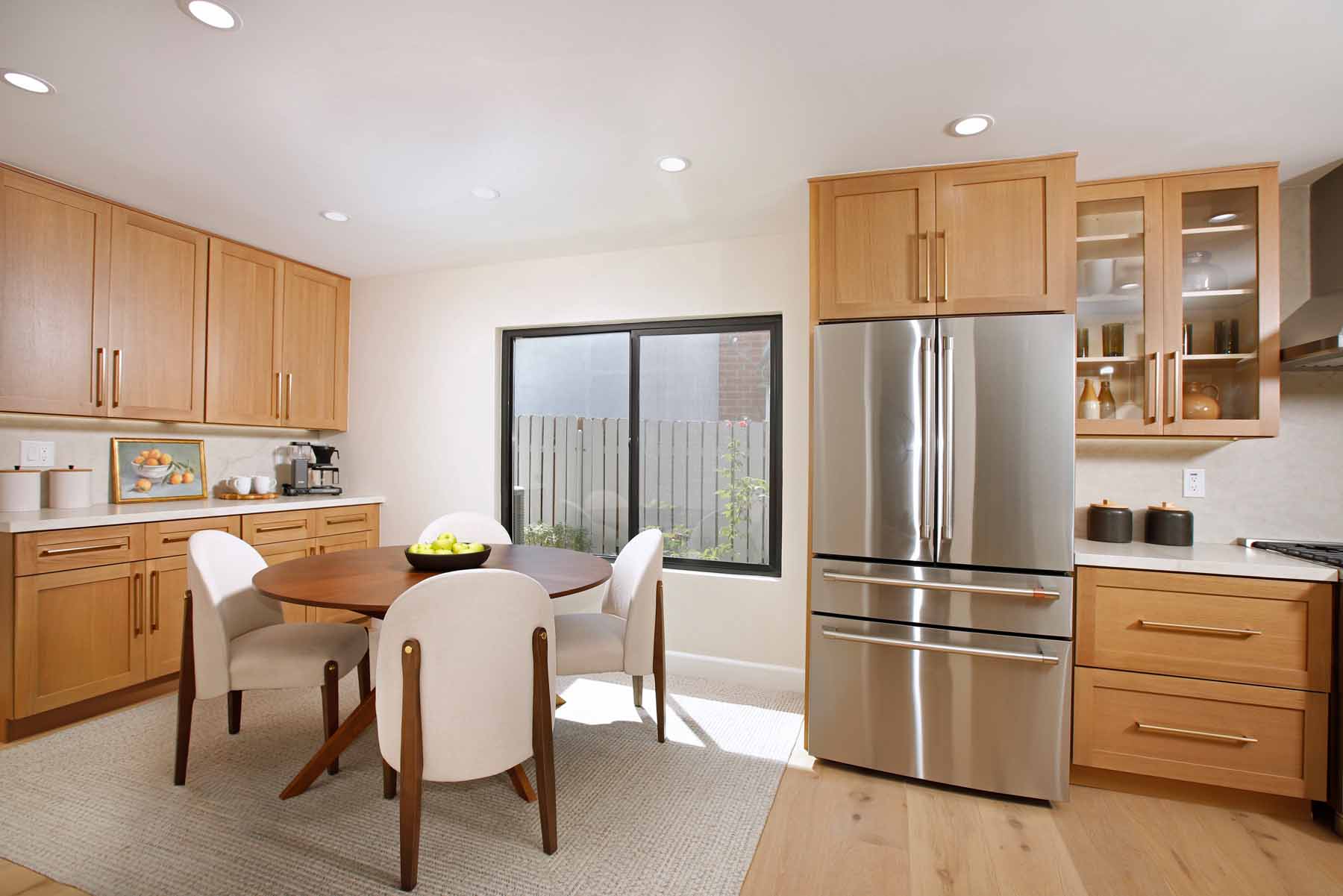 Kitchen and dining nook with stainless refrigerator and glass-front cabinets at 19939 Hemmingway Street, Winnetka
