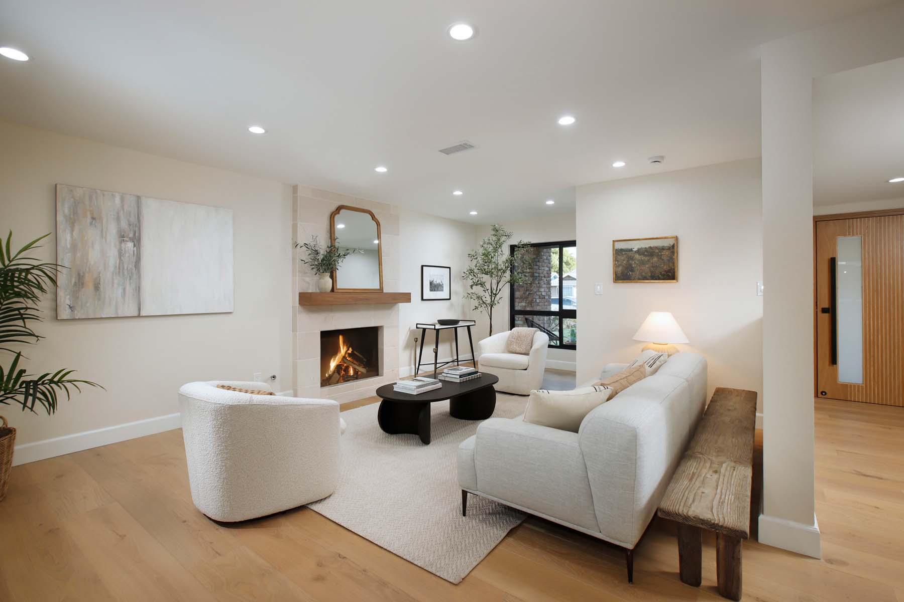 Living room with tumbled-marble fireplace and white oak floors at 19939 Hemmingway Street, Winnetka