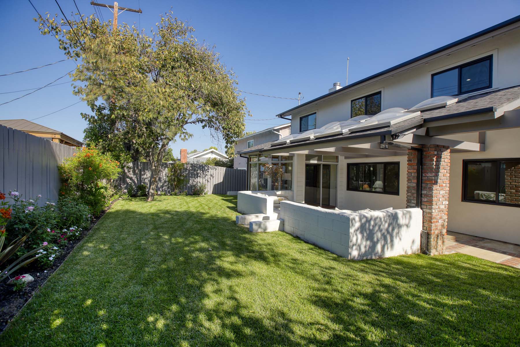 Rear exterior and covered patio overlooking the backyard at 19939 Hemmingway Street, Winnetka