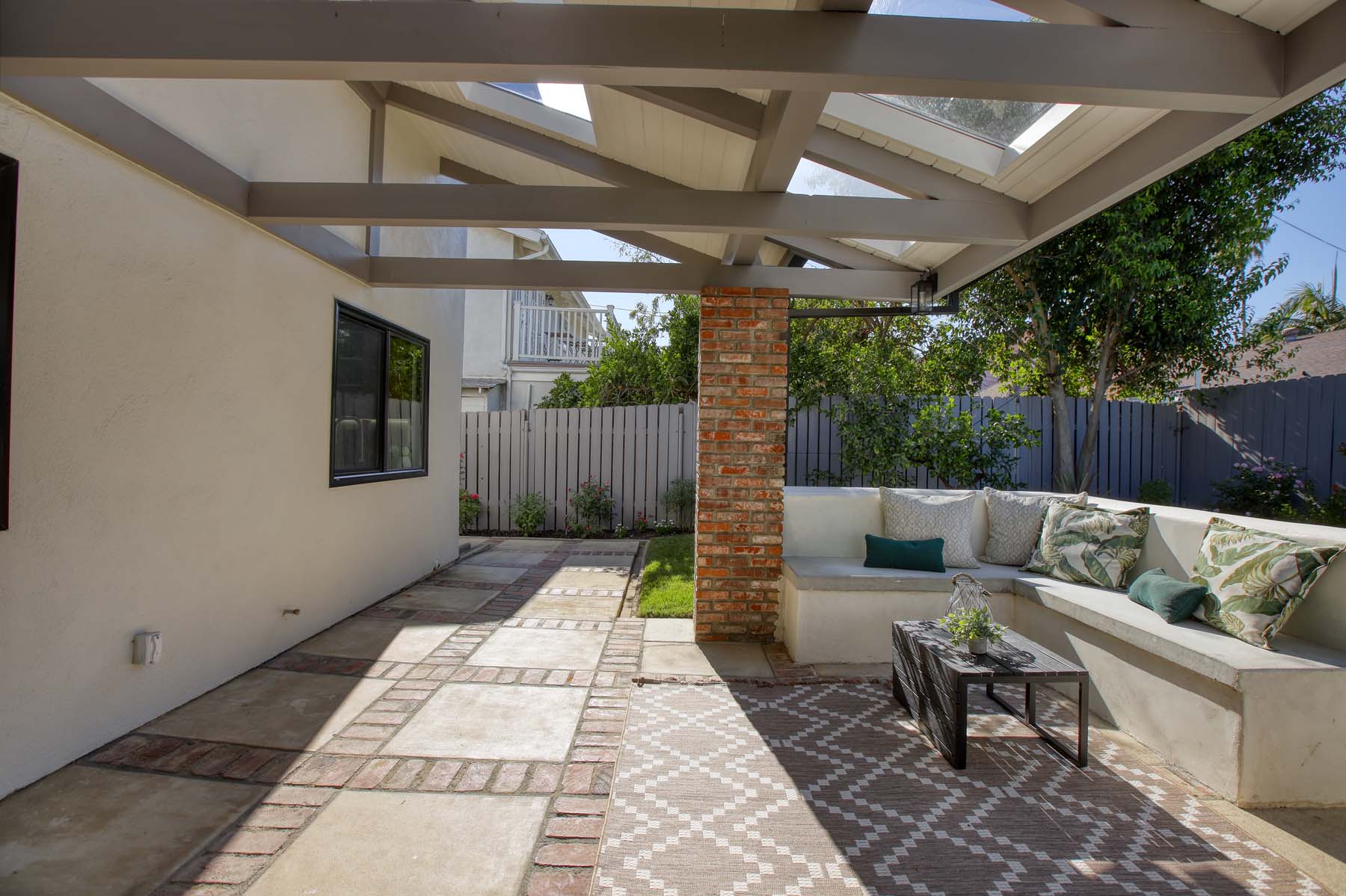 Patio pavers and brick accents beneath the covered outdoor living area at 19939 Hemmingway Street, Winnetka